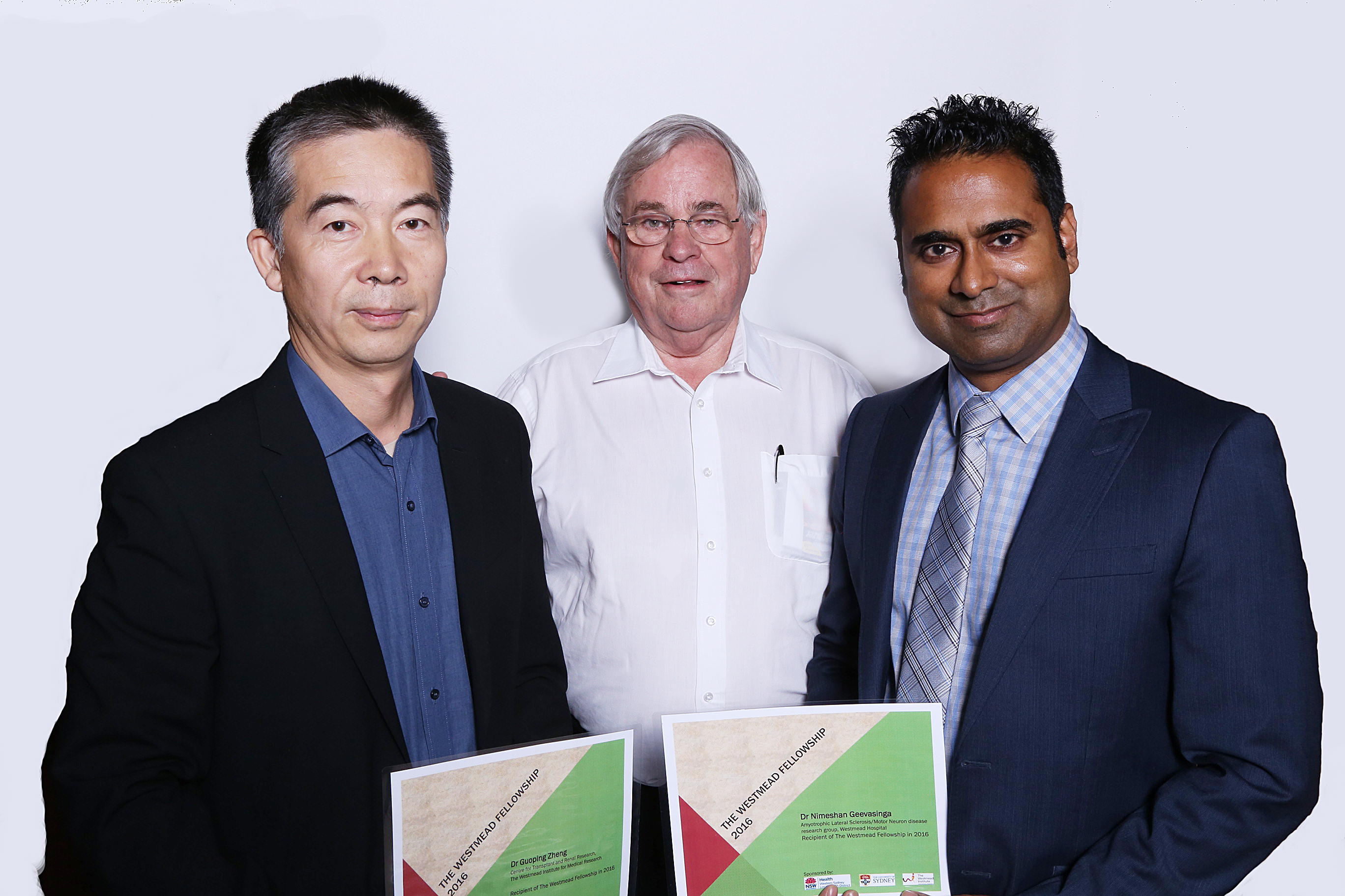 WSLHD Research and Education director Emeritus Professor Stephen Leeder (centre) presents Dr Zheng (left) and Dr Geevasinga